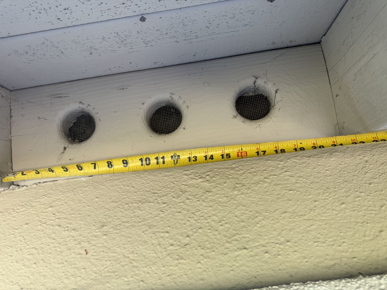 Frieze vents measured with a tape for the compliance record